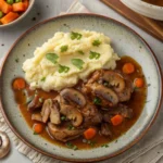 What do you do with the turkey tail? A delicious plate of braised turkey tails with mushrooms, carrots, and rich gravy, served with mashed potatoes and garnished with fresh herbs.