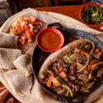 Zilzil tibs served hot in a pan with injera