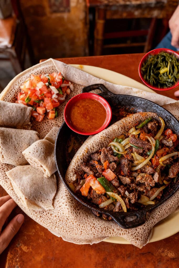 Zilzil tibs served hot in a pan with injera