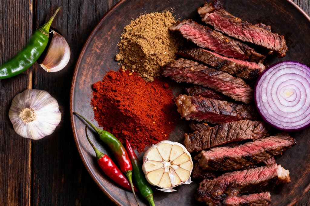 Ingredients for zilzil tibs laid out on wooden table