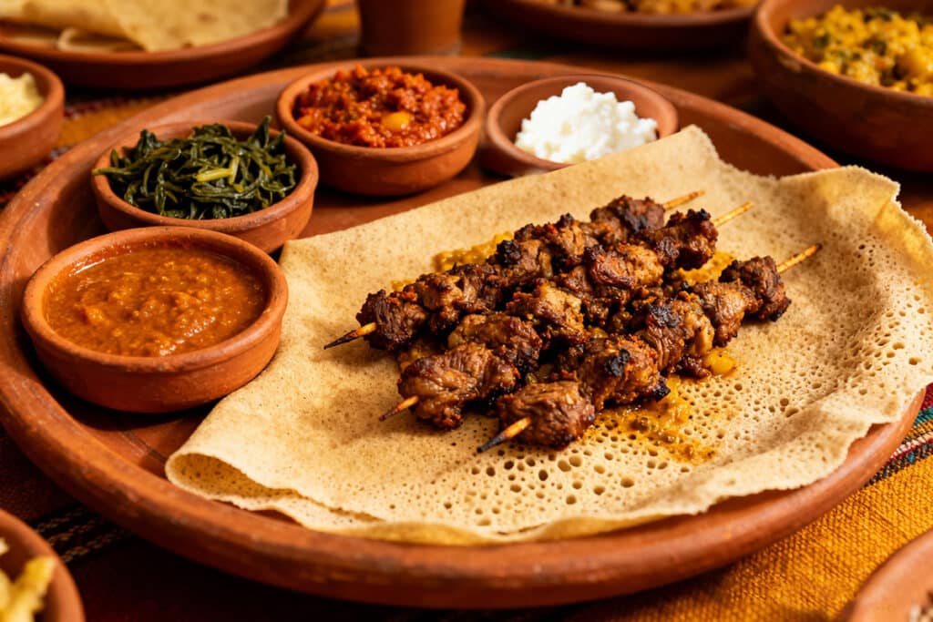 Zilzil tibs plated with injera and sides
