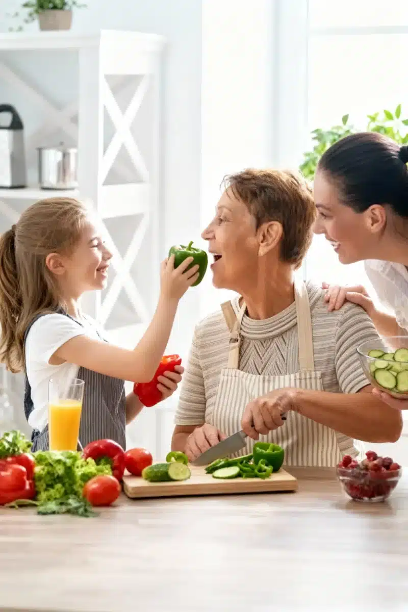 Three generations preparing vegetables together, promoting healthspan longevity through whole foods